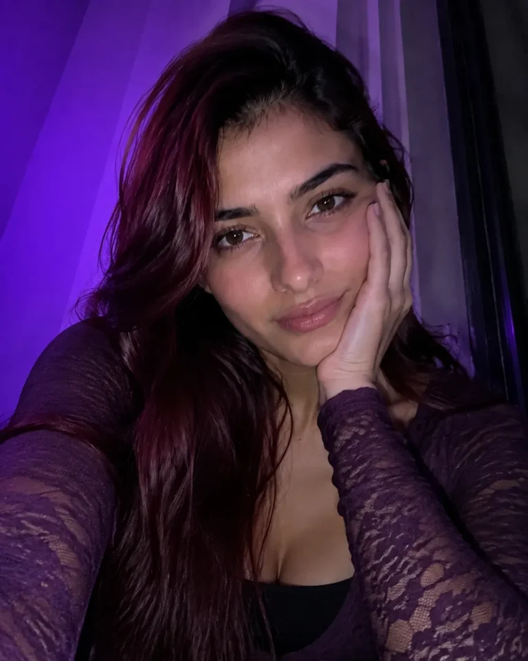 Lacy long sleeve top in a dark purple room